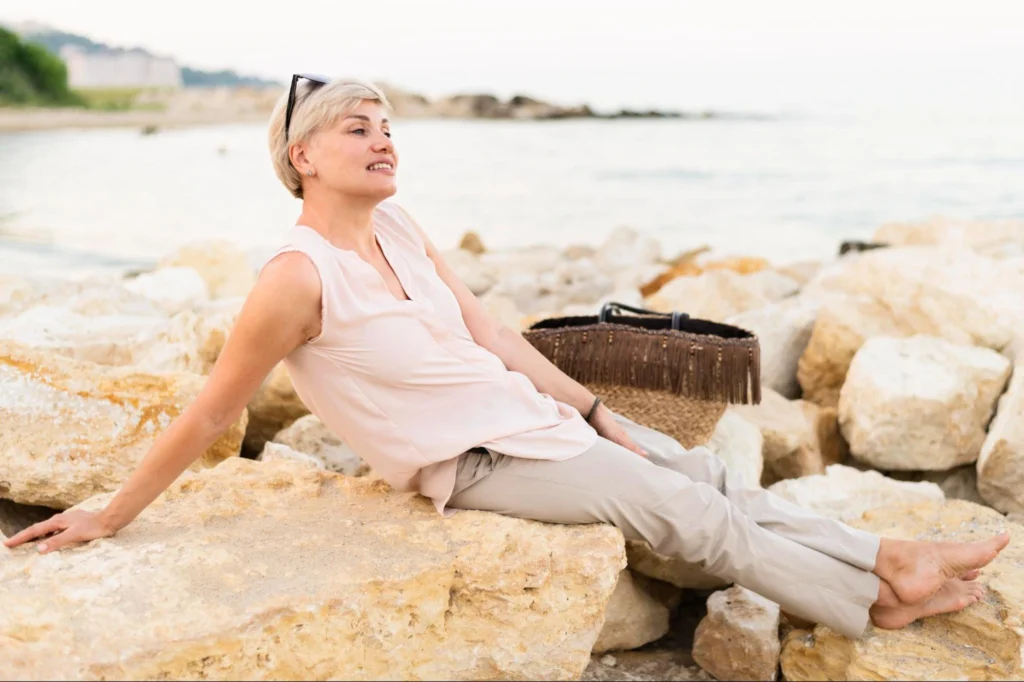 An older woman enjoying life at the beach.